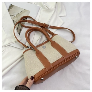 Minimalist PU leather and canvas tote bag with adjustable shoulder strap and metal feet