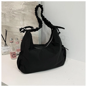 Chic black nylon ruched shoulder bag with cloud texture and silver zipper on white marble