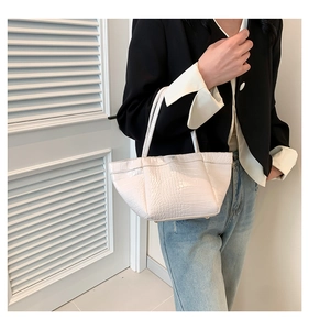 Detail of white crocodile texture on PU leather tote bag shown in a professional commute style