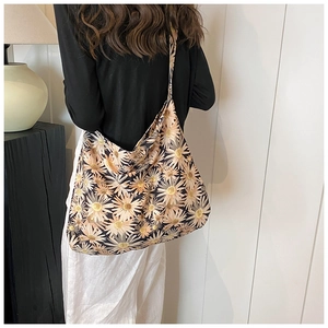 Detailed back view of a large floral tote bag with daisy pattern and wide shoulder strap