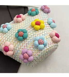 Detail showing 3D colorful padded flowers and zigzag stitching on the woven cotton bag