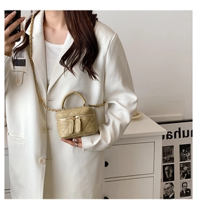 Detail of mini khaki quilted PU leather bag with gold chain and dual zipper closure