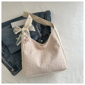 Minimalist cream canvas tote bag with pink floral lace embroidery and ribbon bow charm