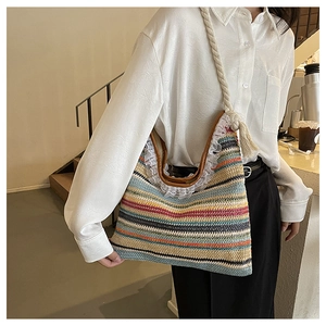 Detail of colorful woven straw tote bag with lace trim and cotton rope shoulder strap
