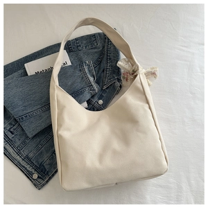 Minimalist cream canvas hobo bag with lace floral bow charm for casual daily use