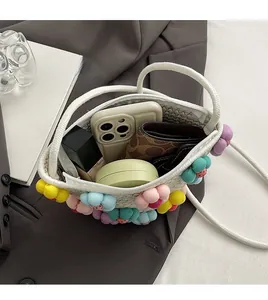 Interior view showing large capacity of woven straw tote bag with phone and cosmetics