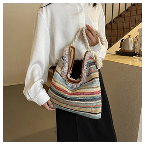 Detail shot of colorful woven summer tote bag with white lace trim and rope handles