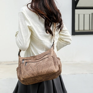 Close-up of vintage brown PU leather crossbody bag with ethnic woven strap detail