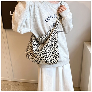 Detail of leopard print hobo bag with wide shoulder strap in canvas material