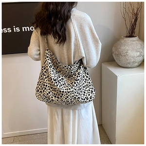 Detailed view of the large leopard print canvas hobo bag with wide shoulder strap