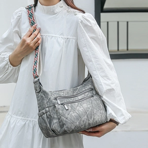 Detail of grey PU crossbody bag with marble texture and geometric pattern strap