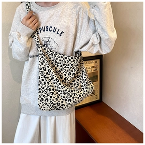 Detail view of high-capacity hobo bag featuring a classic black and white leopard print