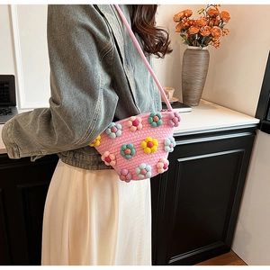 Detail of pink cotton linen crossbody bag with colorful 3D plush flower decorations