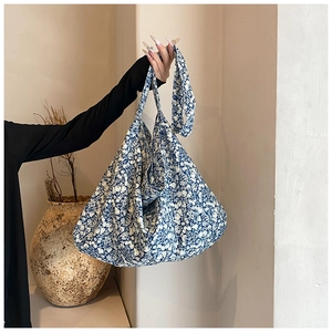 Detail of blue and white tie-dye tote bag with soft fabric texture and wide handle