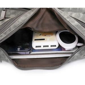 Detail view of the spacious inner compartment and high-quality metal zipper of the grey bag