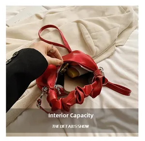 Detail showing red PU leather shoulder bag interior capacity for phone and makeup