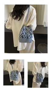 Close-up of distressed denim bucket bag with white diamond lattice pattern and drawstring