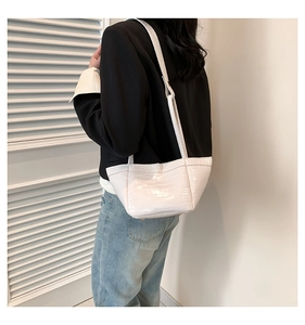 Detail of white crocodile pattern PU leather shoulder bag with sleek minimalist texture