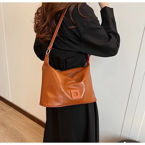 Detailed view of caramel brown PU leather shoulder bag with chic pleated texture design