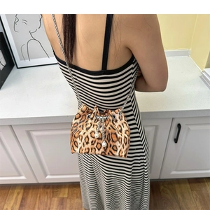 Detail of leopard print bucket bag with silver chain strap and pearl drawstring accents