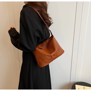 Detailed view of the vintage brown PU leather shoulder bag with decorative stitching and square buckle