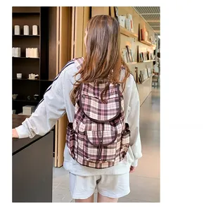 Classic check pattern nylon backpack shown in a cozy cafe setting for a lifestyle look