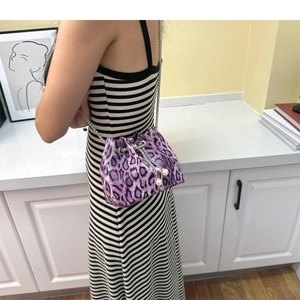 Detail of purple leopard print bucket bag with drawstring closure and pearl charms