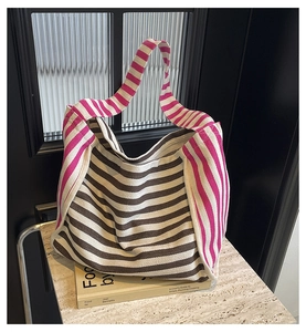 Detail view of the heavy canvas texture and striped pattern of the large tote bag