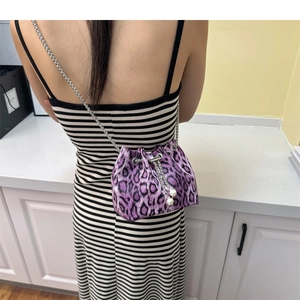 Detail of purple leopard print bucket bag with silver chain and pearl drawstrings
