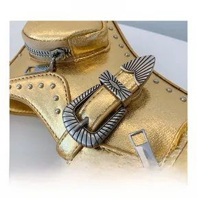 Detailed close-up of metallic PU leather handbag featuring silver studs and a wave buckle