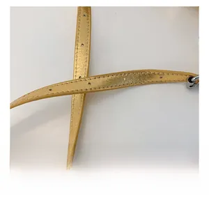 Detailed macro view of the golden PU leather strap with precise stitching and edge oiling