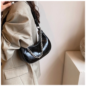 Détail du sac croissant en cuir PU noir brillant avec surpiqûres en losange chic