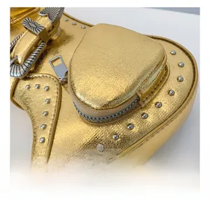 Detail of gold PU saddle bag featuring silver studs and vintage metal buckle closure