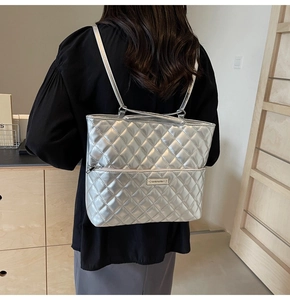 Detail of silver quilted PU handbag with metallic finish and Morolaka brand logo plate