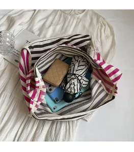 Macro detail of the spacious striped canvas tote bag interior showing storage capacity