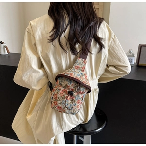 Floral print canvas crossbody bag detail with drawstring closure and fabric strap