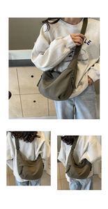 Detail view of large olive green nylon crossbody bag with woven zipper pull and adjustable strap