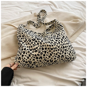 Leopard print canvas tote bag with shoulder strap on soft neutral background