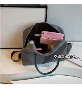 Internal view of a grey canvas handbag showing spacious compartments for gadgets
