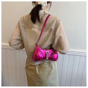 Close-up of metallic magenta PU leather shoulder bag with silver studs and western buckle