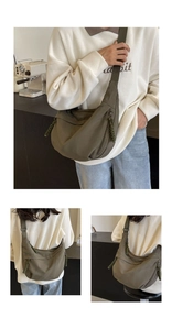 Detail view of olive green nylon dumpling bag with woven zipper pull and large capacity