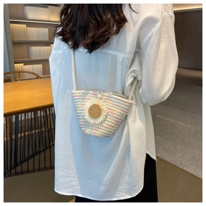 Detail of summer woven mini crossbody bag featuring colorful wave patterns and daisy decor