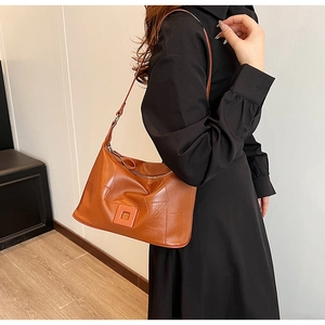 Minimalist caramel PU leather shoulder bag with adjustable strap and decorative square buckle