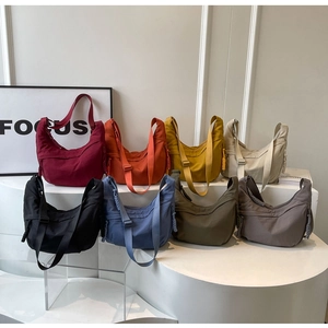 Detailed view of casual nylon crescent crossbody bags in eight various vibrant colors