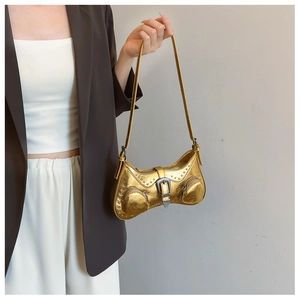 Detail of metallic gold PU shoulder bag with silver rivets and vintage buckle on model