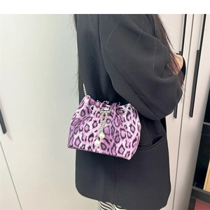 Detail of purple leopard print bucket bag with metal chain strap and pearl charms