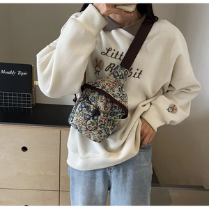 Floral crossbody chest bag in jacquard fabric styled with a casual mirror selfie