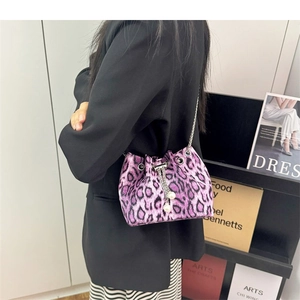 Detail of purple leopard print bucket bag with silver chain and white pearl charms