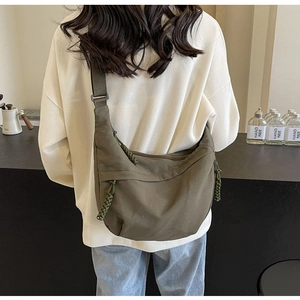 Army green nylon dumpling bag showing large capacity and adjustable wide shoulder strap