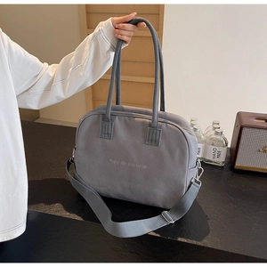 Detail of grey canvas tote bag featuring Enjoy life and travel print and top handles